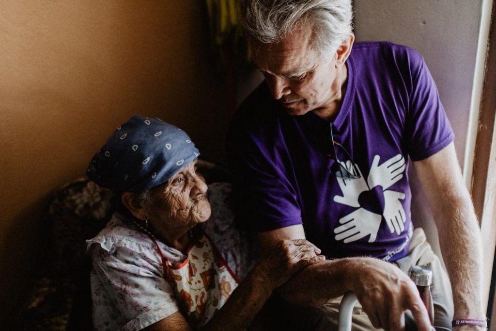 puertorico_pr_usa_hurricane_volunteer_beneficiary_couple_smiling_hugging