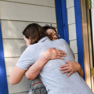 An All Hands and Hearts - Smart Response staff member embracing a survivor