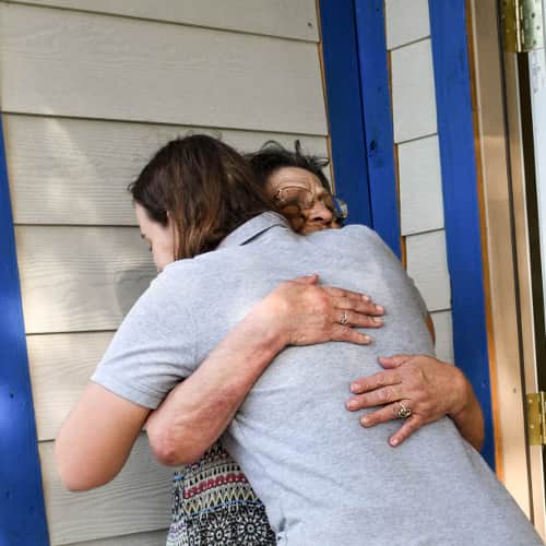 Volunteer-Homeowner-Hugging-Emotional.jpg An All Hands and Hearts - Smart Response staff member embracing a survivor