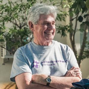 Co-founder David Campbell smiling in an All Hands and Hearts - Smart Response volunteer shirt