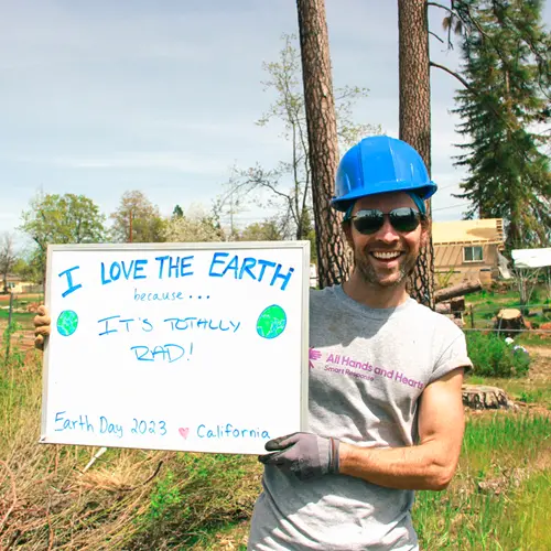 staff holding whiteboard reading I love that the earth because it's totally read earth day 2023 California