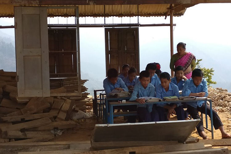 Students studying at a desk outside