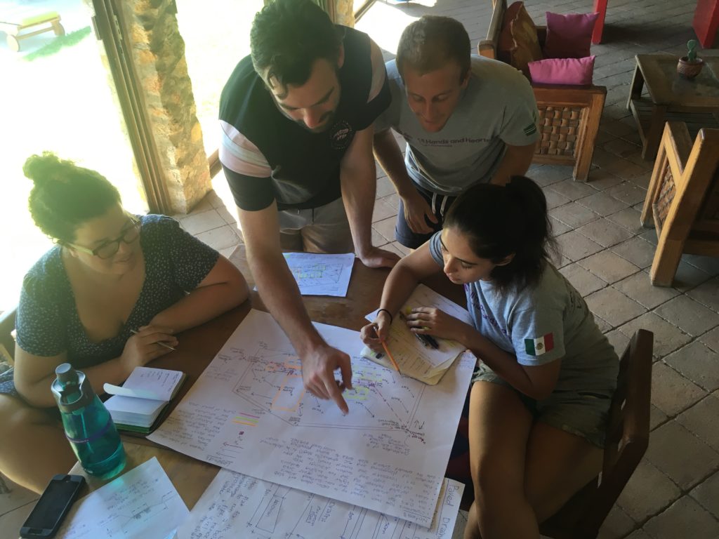 three people looking at a document on a table