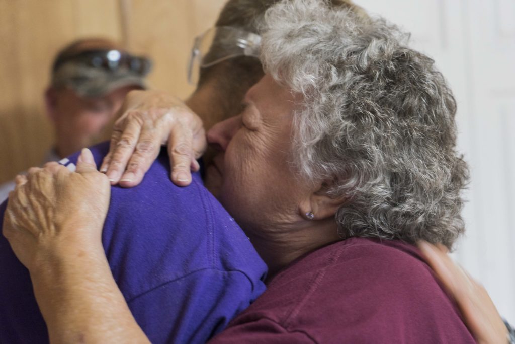beneficiary hugging a staff member