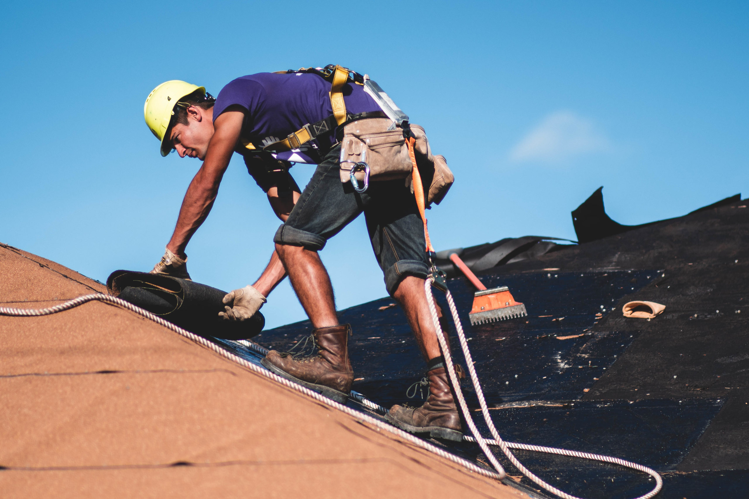 Person in a harness on a roof