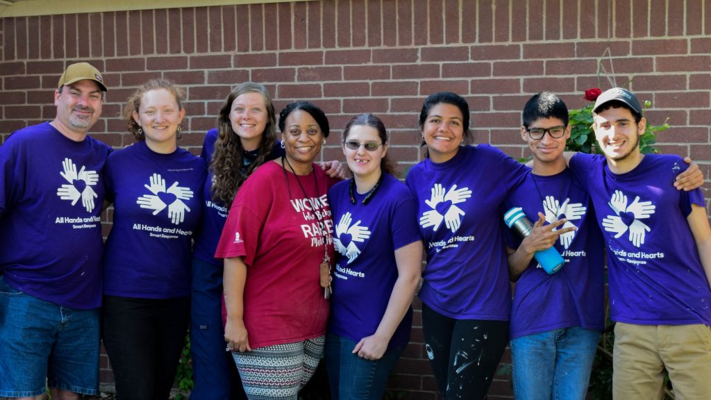 houston_texas_usa_hurricane_volunteer_beneficiary_group_smiling_hugging