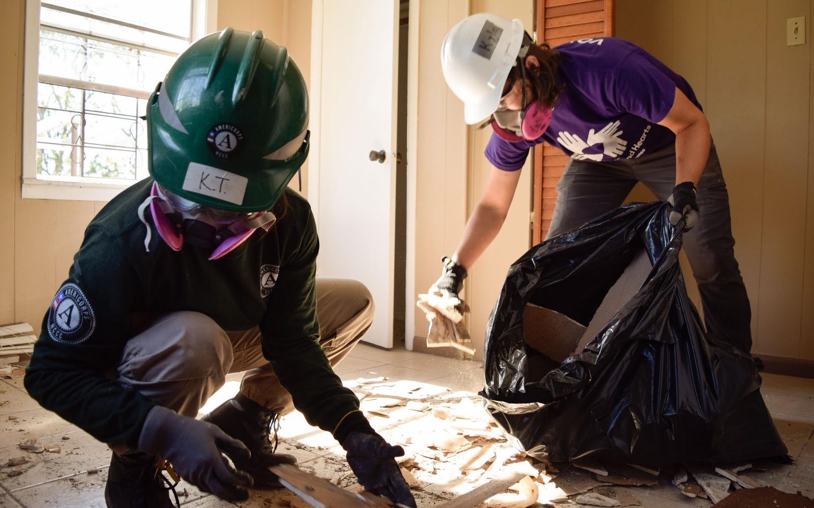 two volunteers removing debris