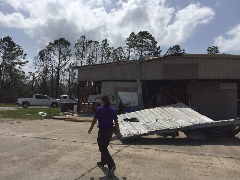 staff walking towards debris