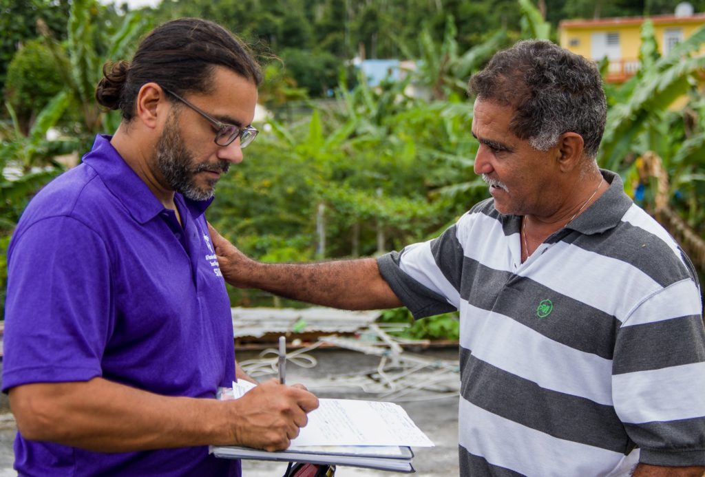 Staff member talking with a beneficiary