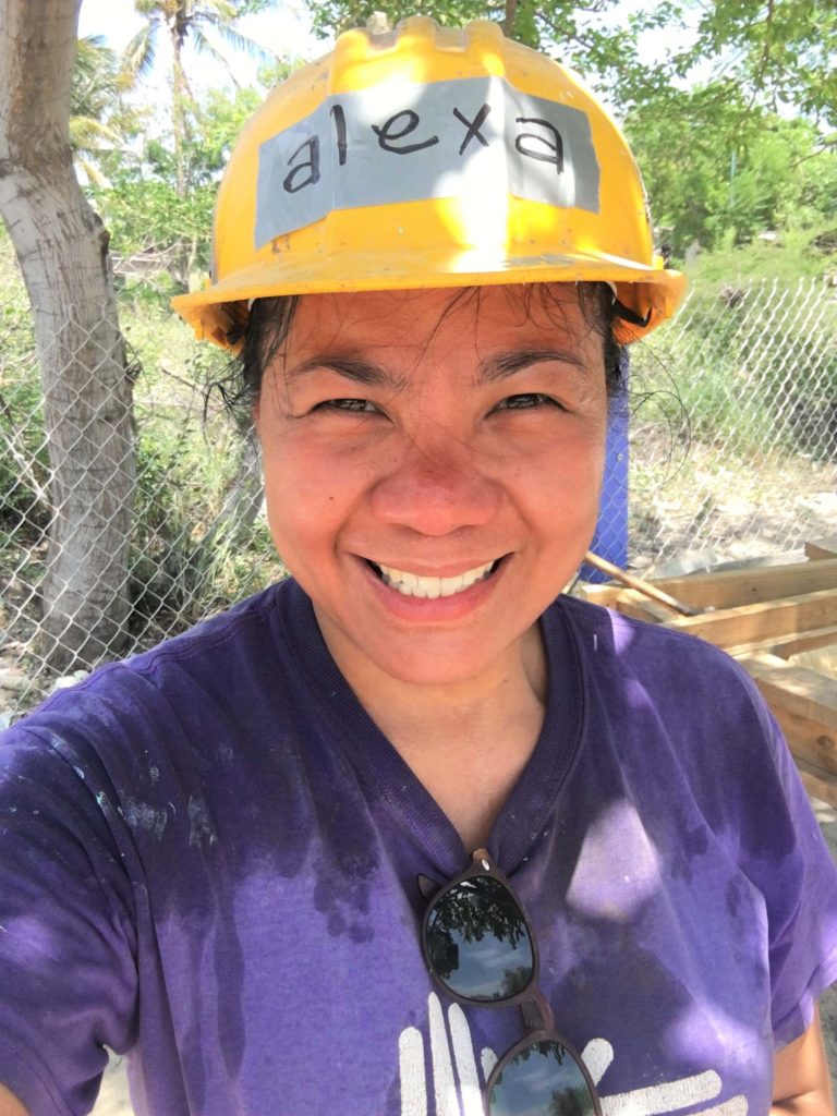 a volunteer wearing a hardhat smiling