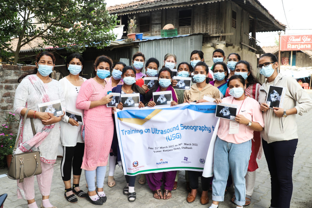 Group of women standing with masks on