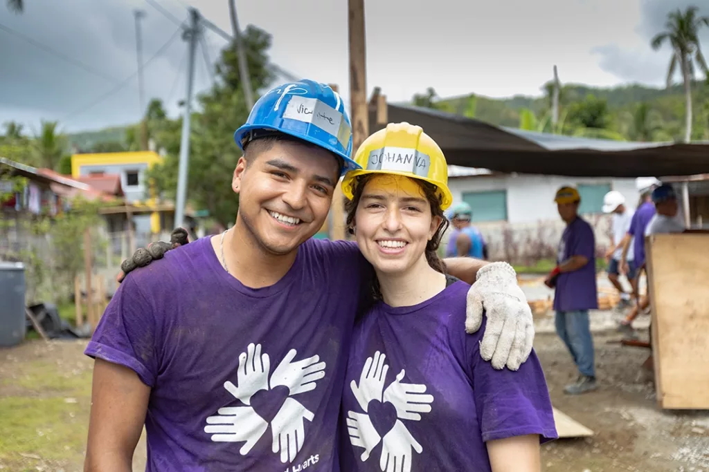 Two volunteers smiling at camera