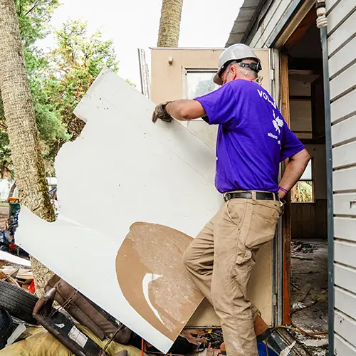 removing debris from damaged home